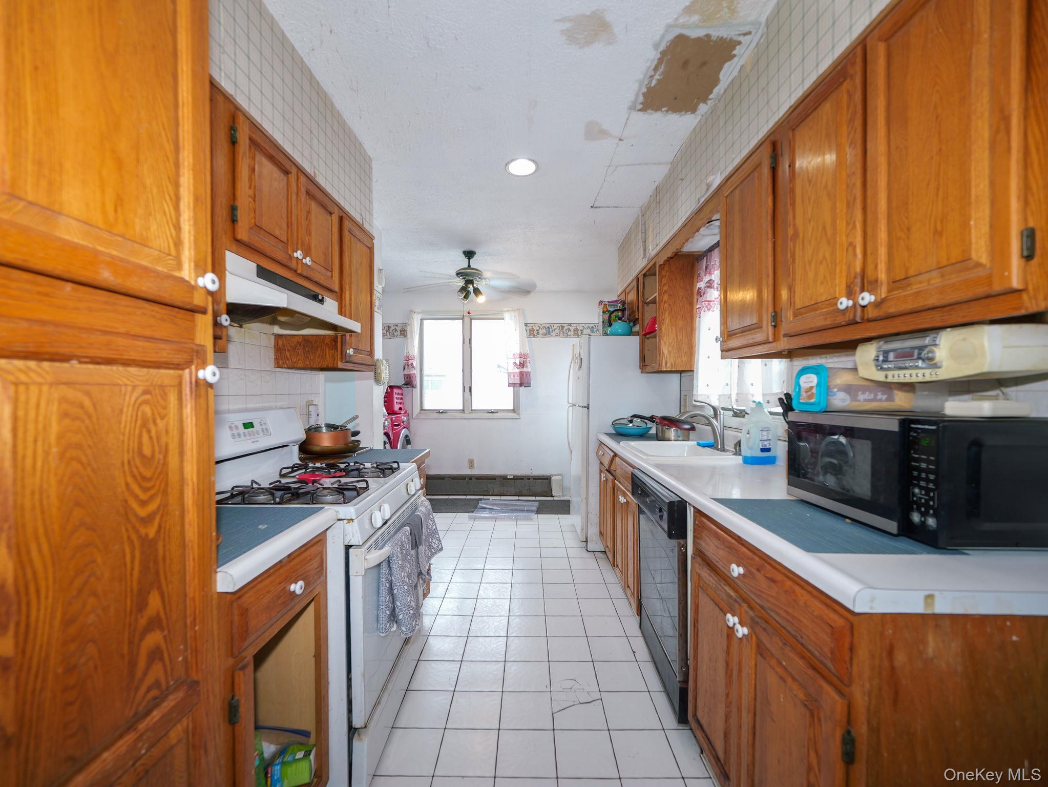 809 South Street Newburgh, NY 12550 - Photo 15 of 45 a kitchen with stainless steel appliances granite countertop a stove top oven a sink dishwasher and cabinets with wooden floor
