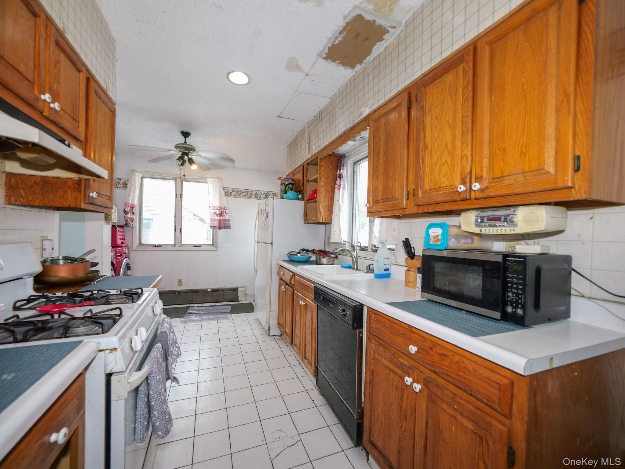 809 South Street Newburgh, NY 12550 - Photo 16 of 45 a kitchen with stainless steel appliances a stove a sink a counter space and cabinets