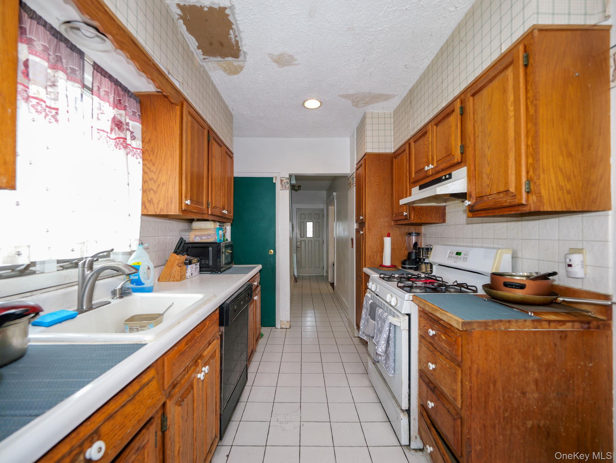 809 South Street Newburgh, NY 12550 - Photo 19 of 45 a kitchen with stainless steel appliances granite countertop a sink a stove and a refrigerator