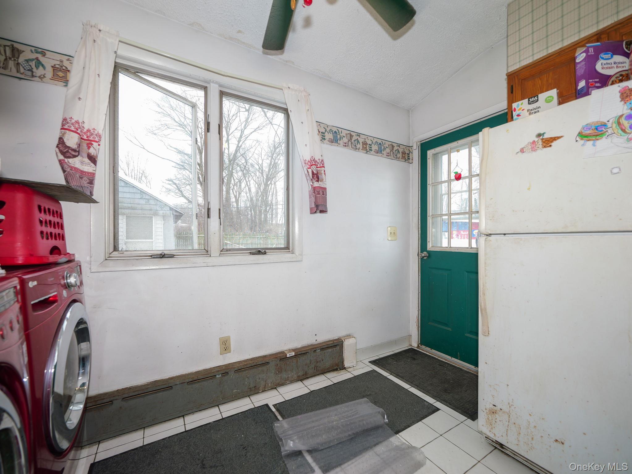 809 South Street Newburgh, NY 12550 - Photo 22 of 45 a kitchen with a refrigerator and window