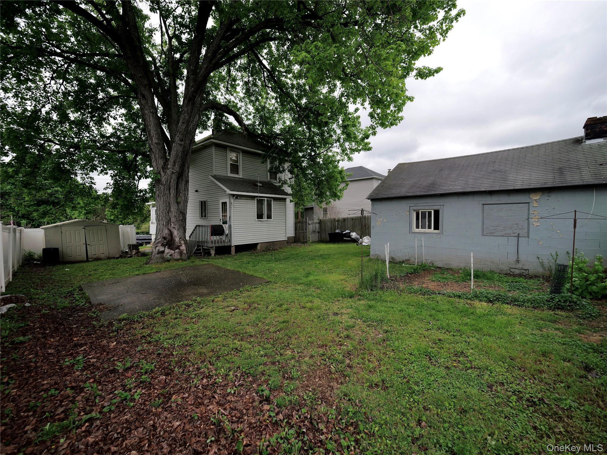 809 South Street Newburgh, NY 12550 - Photo 24 of 45 a front view of a house with a yard and trees