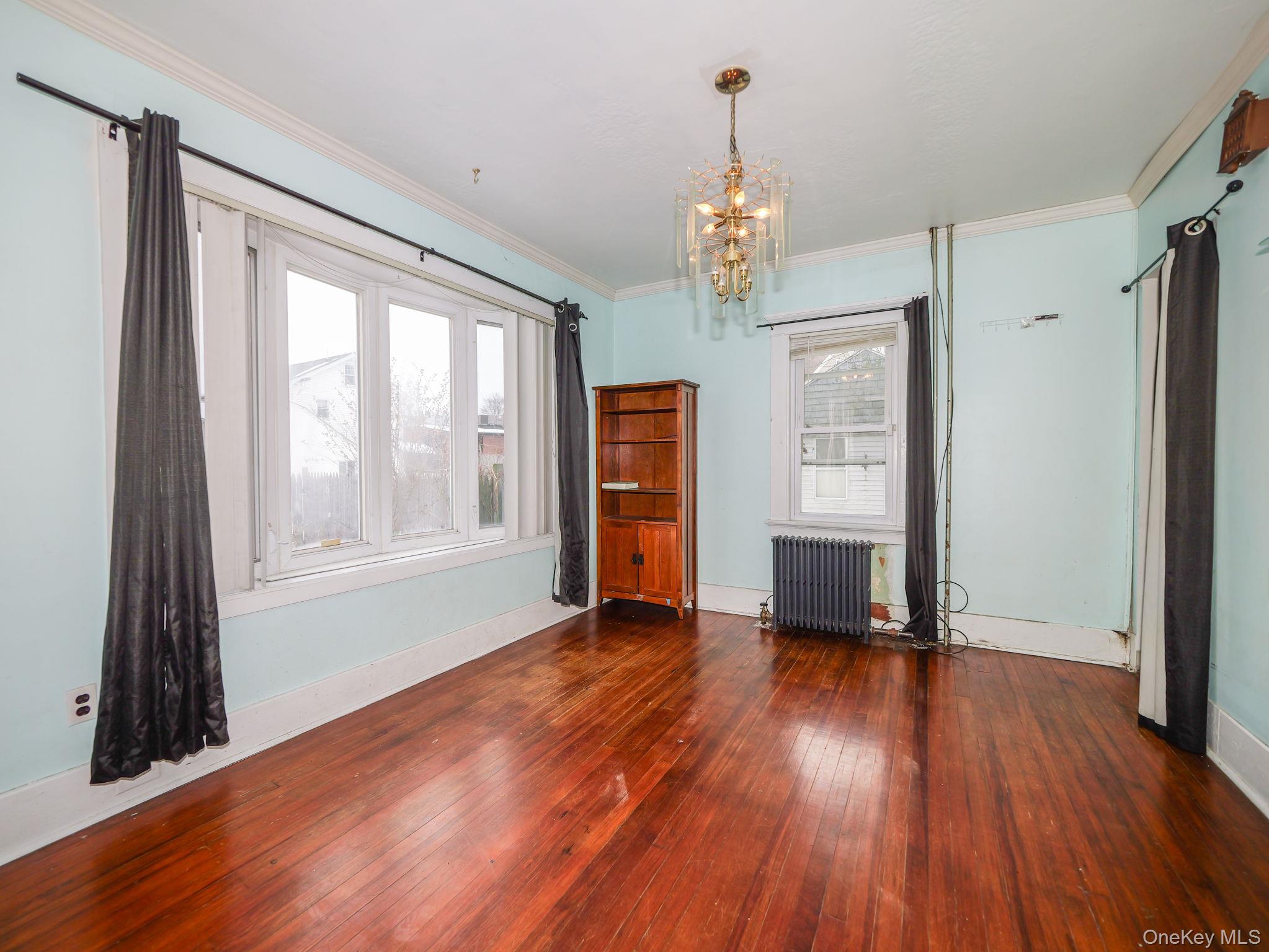 809 South Street Newburgh, NY 12550 - Photo 3 of 45 a view of an empty room with wooden floor and a window
