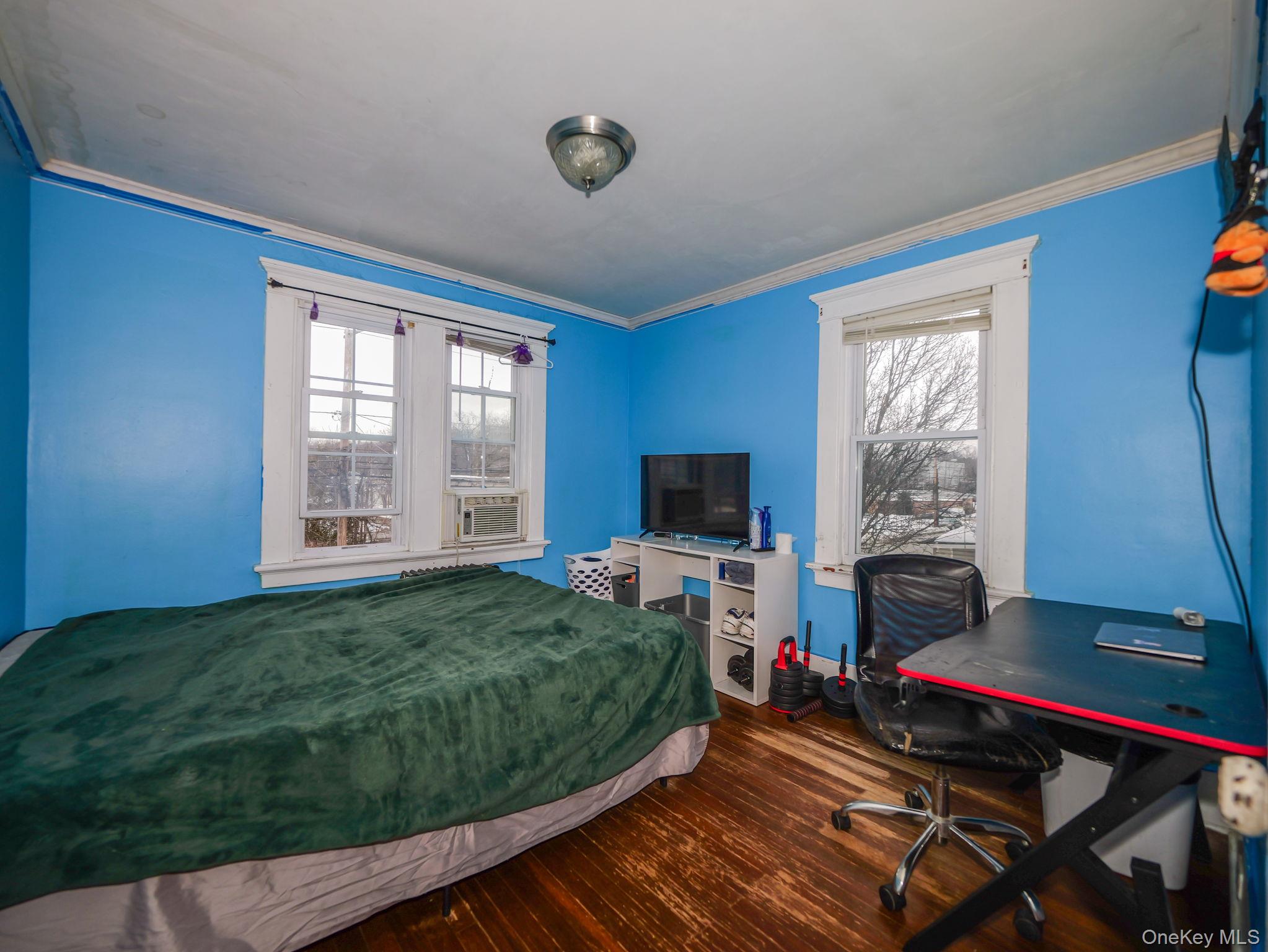809 South Street Newburgh, NY 12550 - Photo 34 of 45 a bedroom with a bed and a flat screen tv
