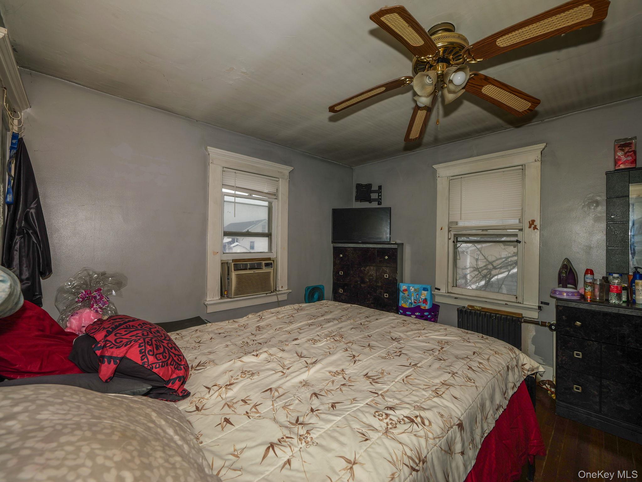 809 South Street Newburgh, NY 12550 - Photo 37 of 45 a bedroom with a bed next to a window with a flat screen tv