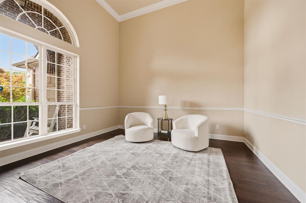 7013 Handel Colleyville, TX 76034 - Photo 9 of 37 Spacious interior room featuring a large arched window, tall vaulted ceiling, dark wood-finish flooring, and crown molding accents