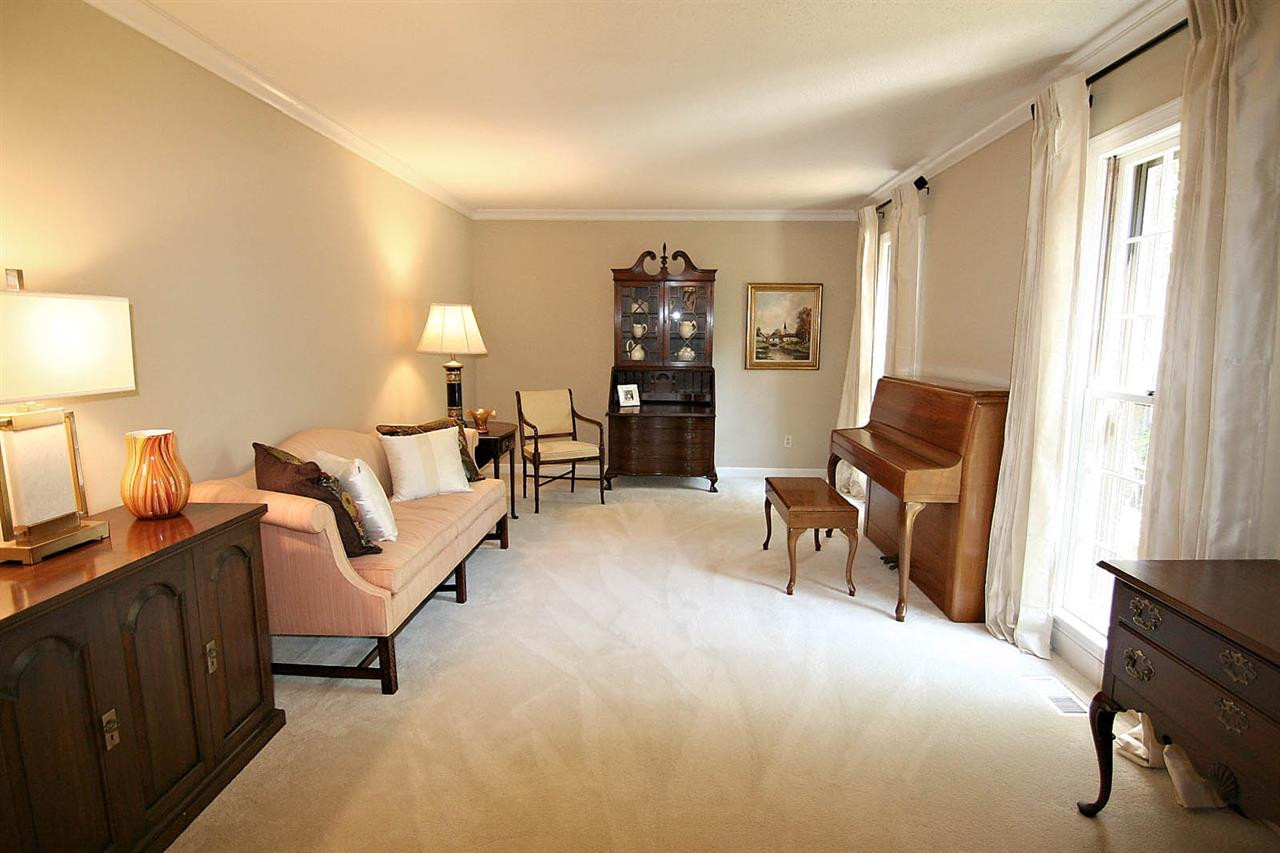 8005 Shellnut Road Raleigh, NC 27615 - Photo 5 of 25 You will Fall in Love with the Spacious Formal Living Room with the Timeless Style of Crown Molding and Floor-to-Ceiling Windows. Living Room