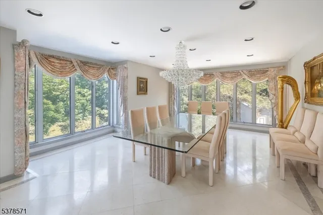 a view of a dining room with furniture large windows and wooden floor