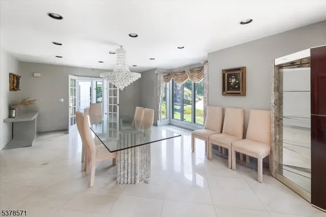 a living room with furniture a lamp and a dining table