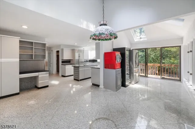 a view of a kitchen with refrigerator and microwave