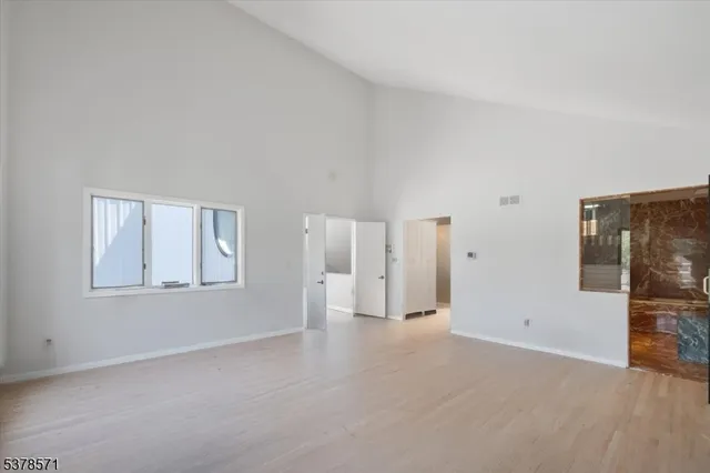 a bathroom with a granite countertop sink a mirror and a shower