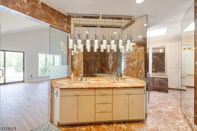 a bathroom with a granite countertop sink and a mirror