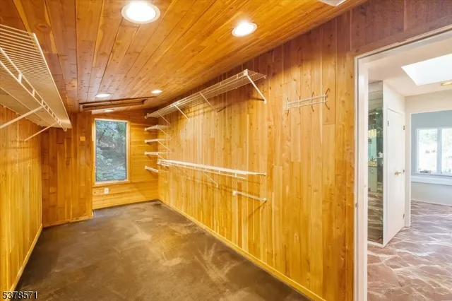 a view of empty room with window and wooden floor