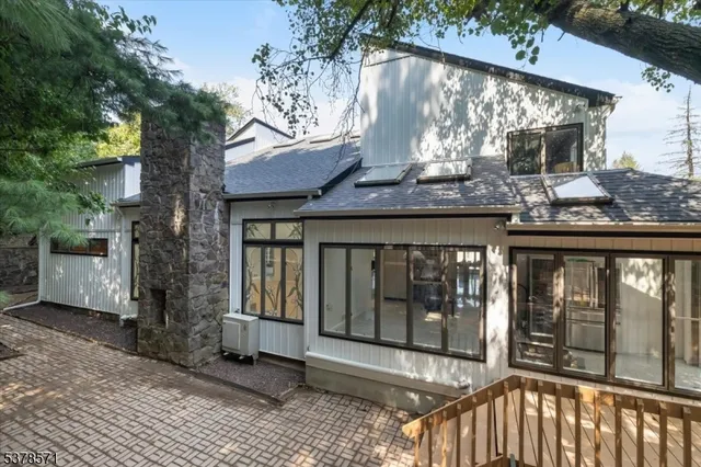 a view of a small house with wooden fence