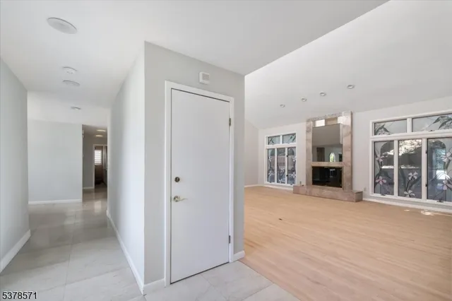 a view of an entrance with wooden floor and windows