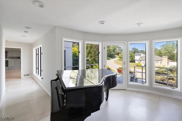a living room with furniture and large windows