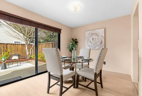 a view of a dining room with furniture wooden floor and a floor to ceiling window