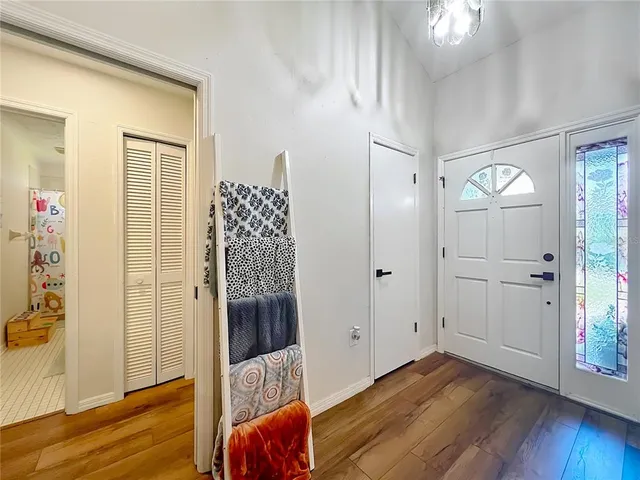 a dining room with furniture a chandelier and window