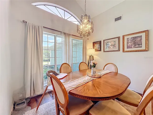 a living room with furniture and a fireplace with kitchen view