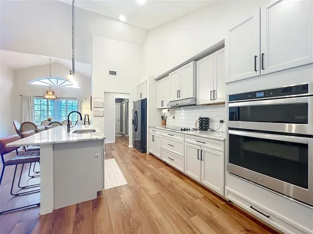 a spacious bathroom with double vanity and a mirror