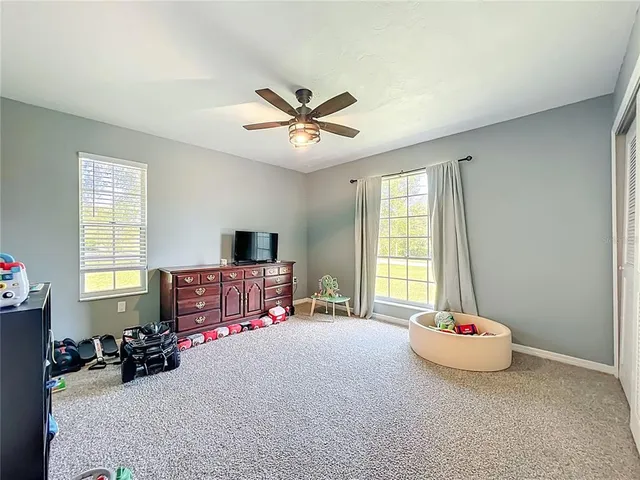 a living room with furniture a rug and a window