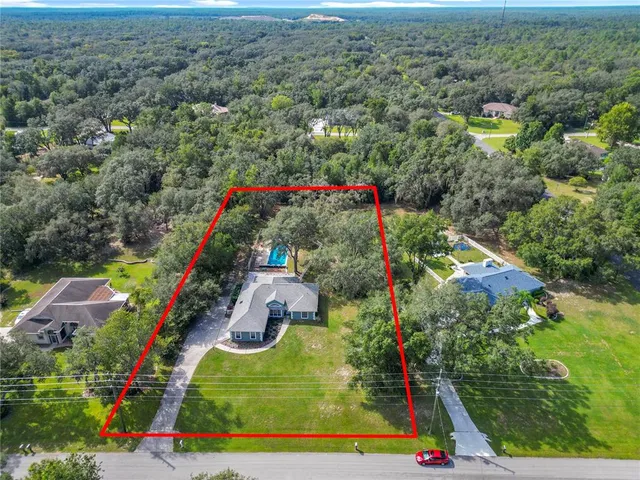 an aerial view of residential houses with outdoor space and street view