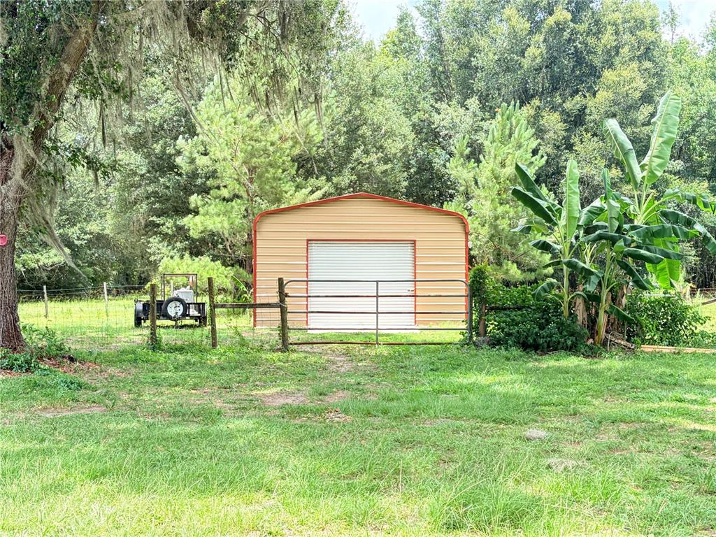 17900 Northwest 120th Avenue Road Reddick, FL 32686 - Photo 3 of 45 a backyard of a house with table and chairs