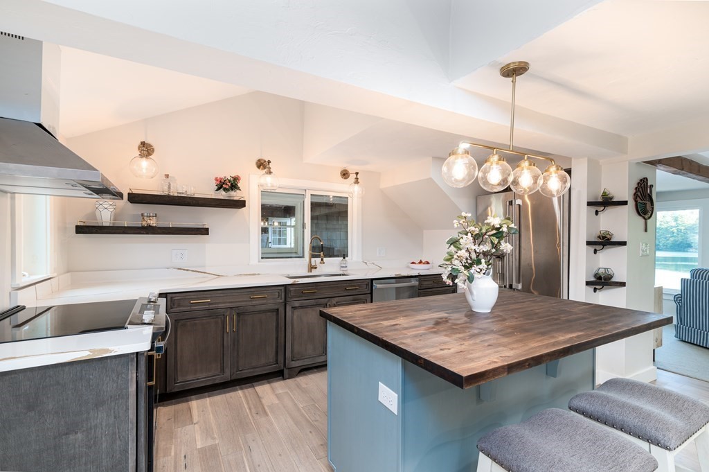 46 Oak Place Halifax, MA 02338 - Photo 10 of 42 a kitchen with granite countertop kitchen island stainless steel appliances a sink and living room view