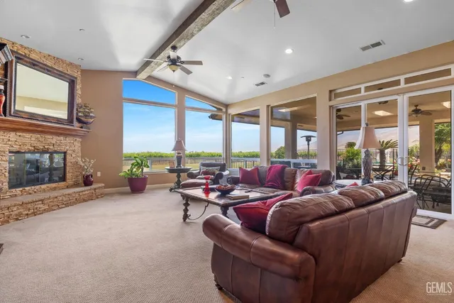 a kitchen with stainless steel appliances granite countertop table chairs sink and cabinets