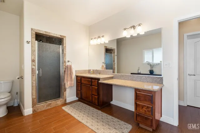 a spacious bathroom with a granite countertop sink and a mirror