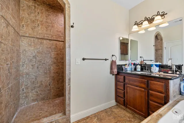 a view of a patio with a table and chairs under an umbrella