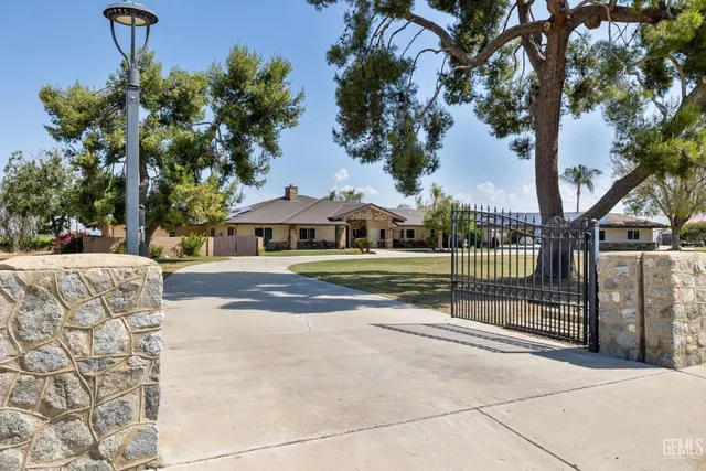 a front view of a house with a yard and fountain
