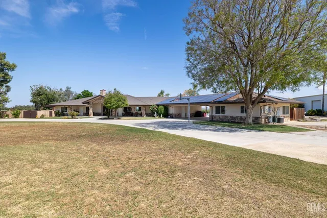 a view of a patio with couches and a fire pit