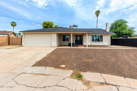 a front view of a house with a yard and a garage