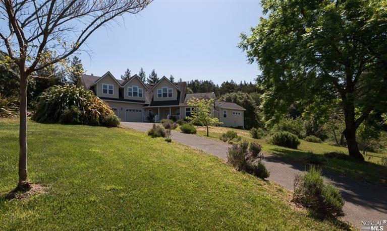 a view of a garden with a house