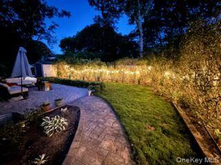 24 Woodridge Road Hampton Bays, NY 11946 - Photo 1 of 18 a view of an outdoor space yard patio and fire pit
