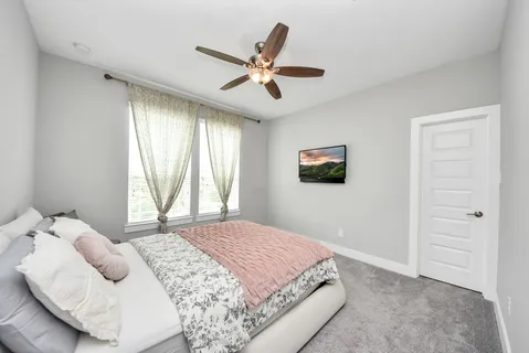 a bedroom with a large bed and a window