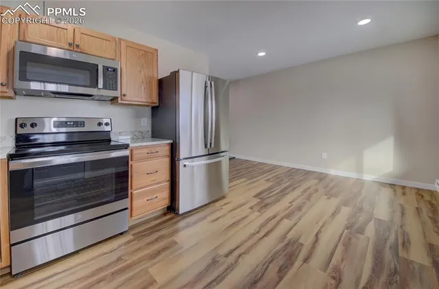 a kitchen with stainless steel appliances a stove a microwave and sink