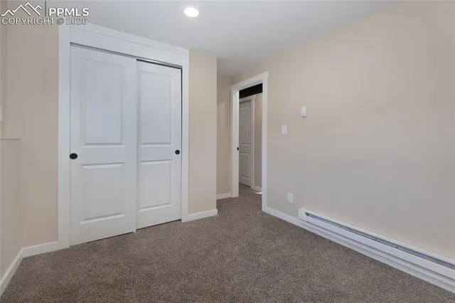 an empty room with closet area