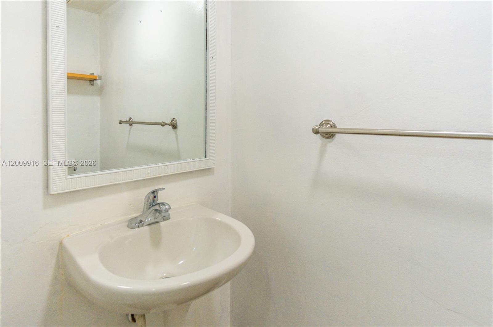 14905 Southwest 80th Street, Unit 212 Miami, FL 33193 - Photo 12 of 37 a bathroom with a sink and a mirror