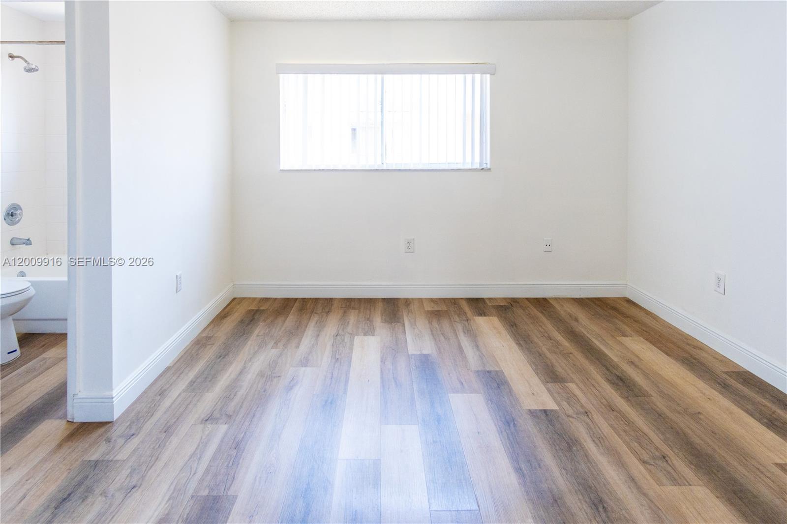14905 Southwest 80th Street, Unit 212 Miami, FL 33193 - Photo 14 of 37 a view of a room with wooden floor and a window