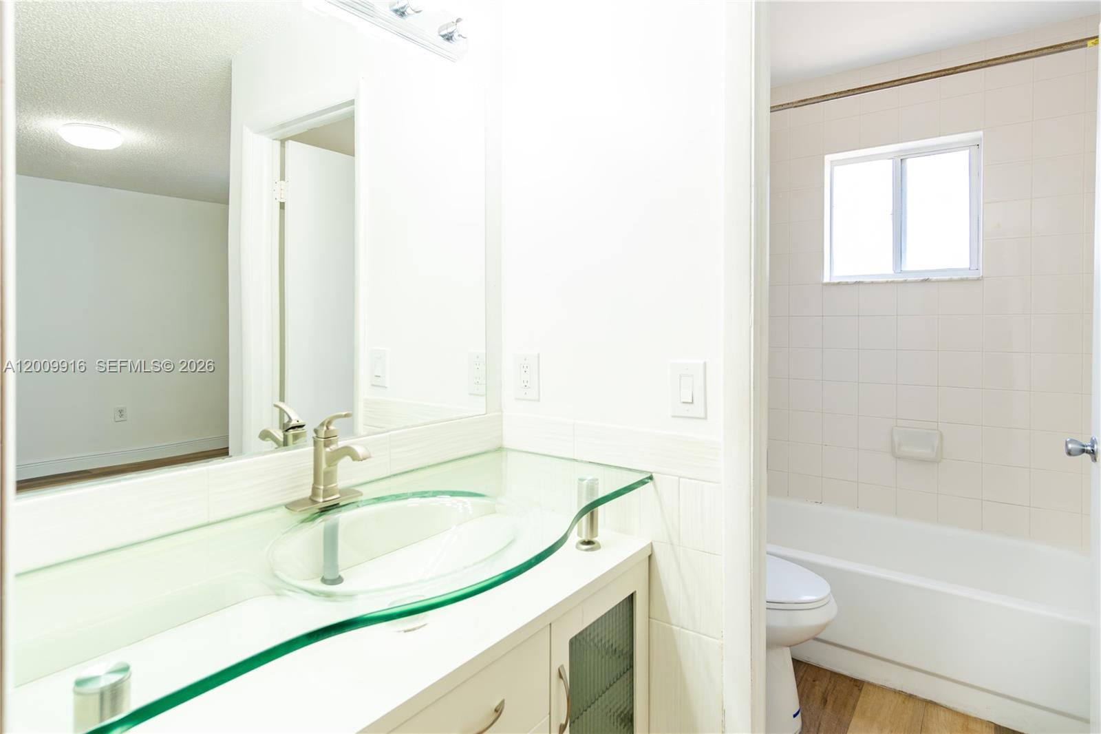 14905 Southwest 80th Street, Unit 212 Miami, FL 33193 - Photo 16 of 37 a bathroom with a sink and a bathtub