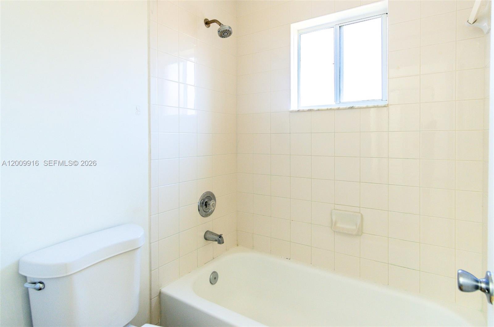 14905 Southwest 80th Street, Unit 212 Miami, FL 33193 - Photo 17 of 37 a bathroom with a bathtub and a toilet