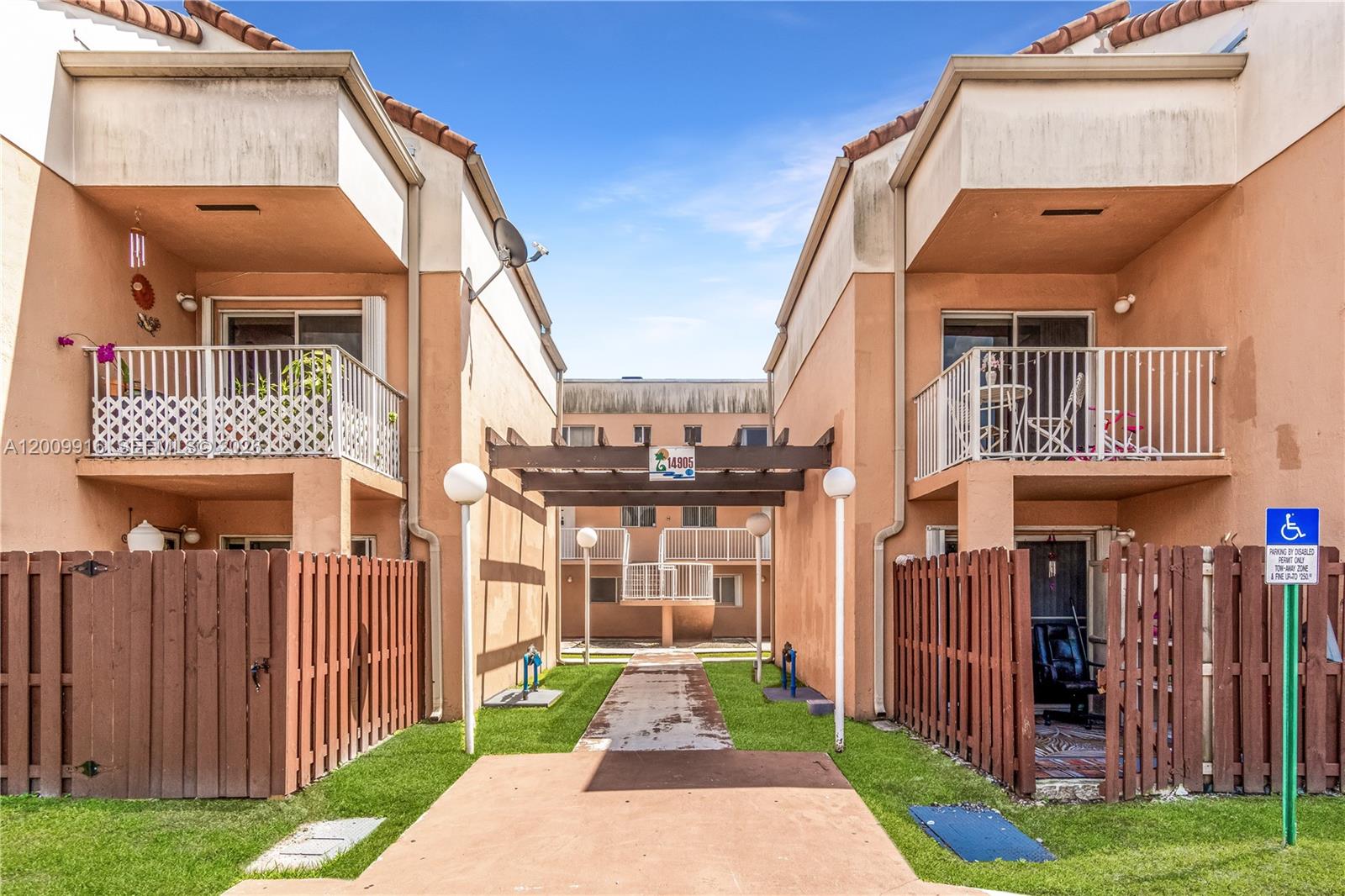 14905 Southwest 80th Street, Unit 212 Miami, FL 33193 - Photo 2 of 37 a front view of a house with a yard