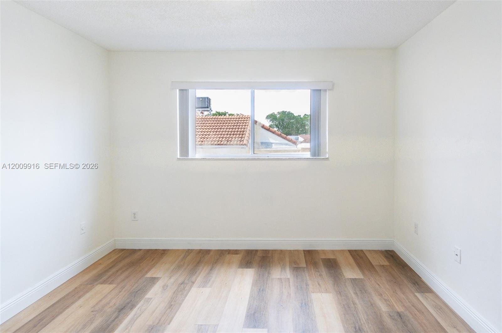 14905 Southwest 80th Street, Unit 212 Miami, FL 33193 - Photo 21 of 37 an empty room with a window