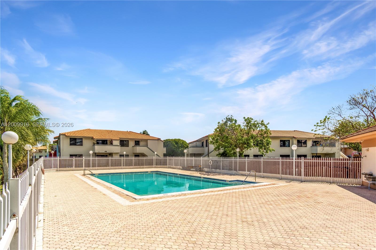 14905 Southwest 80th Street, Unit 212 Miami, FL 33193 - Photo 29 of 37 a view of swimming pool with a yard in the background
