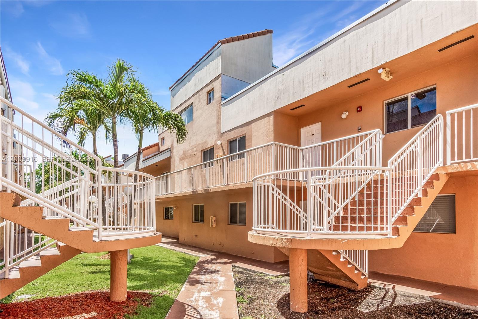 14905 Southwest 80th Street, Unit 212 Miami, FL 33193 - Photo 3 of 37 a front view of a building with a garden