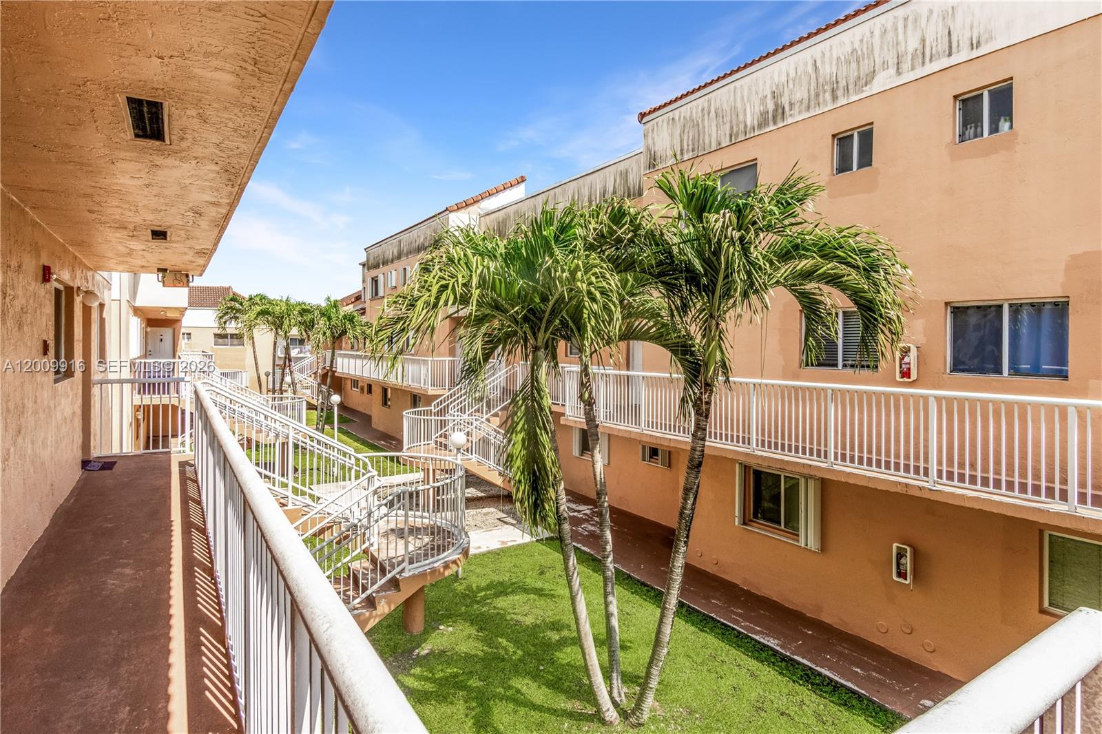 14905 Southwest 80th Street, Unit 212 Miami, FL 33193 - Photo 35 of 37 a balcony with table and chairs