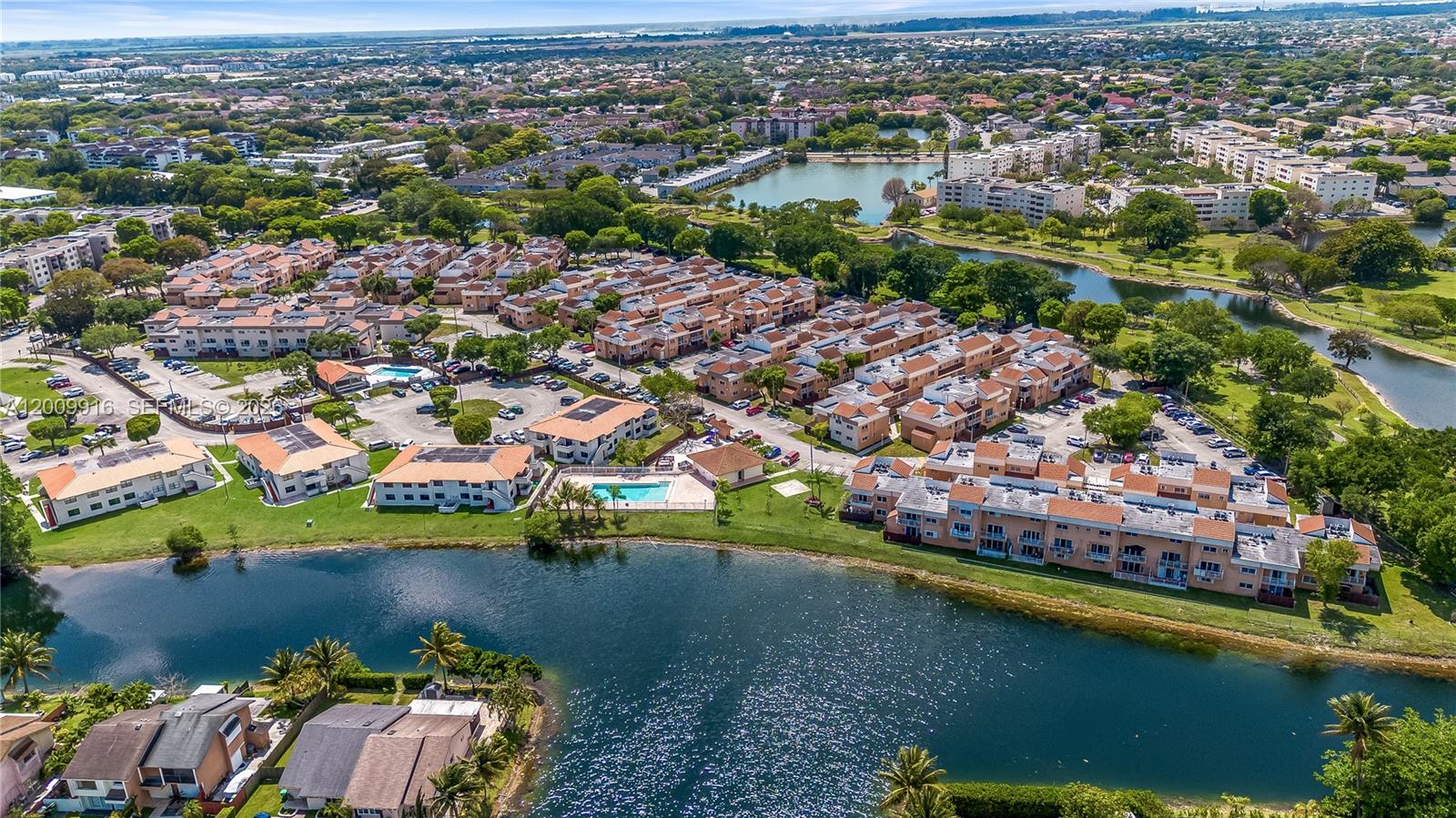 14905 Southwest 80th Street, Unit 212 Miami, FL 33193 - Photo 36 of 37 an aerial view of residential houses with outdoor space and lake view