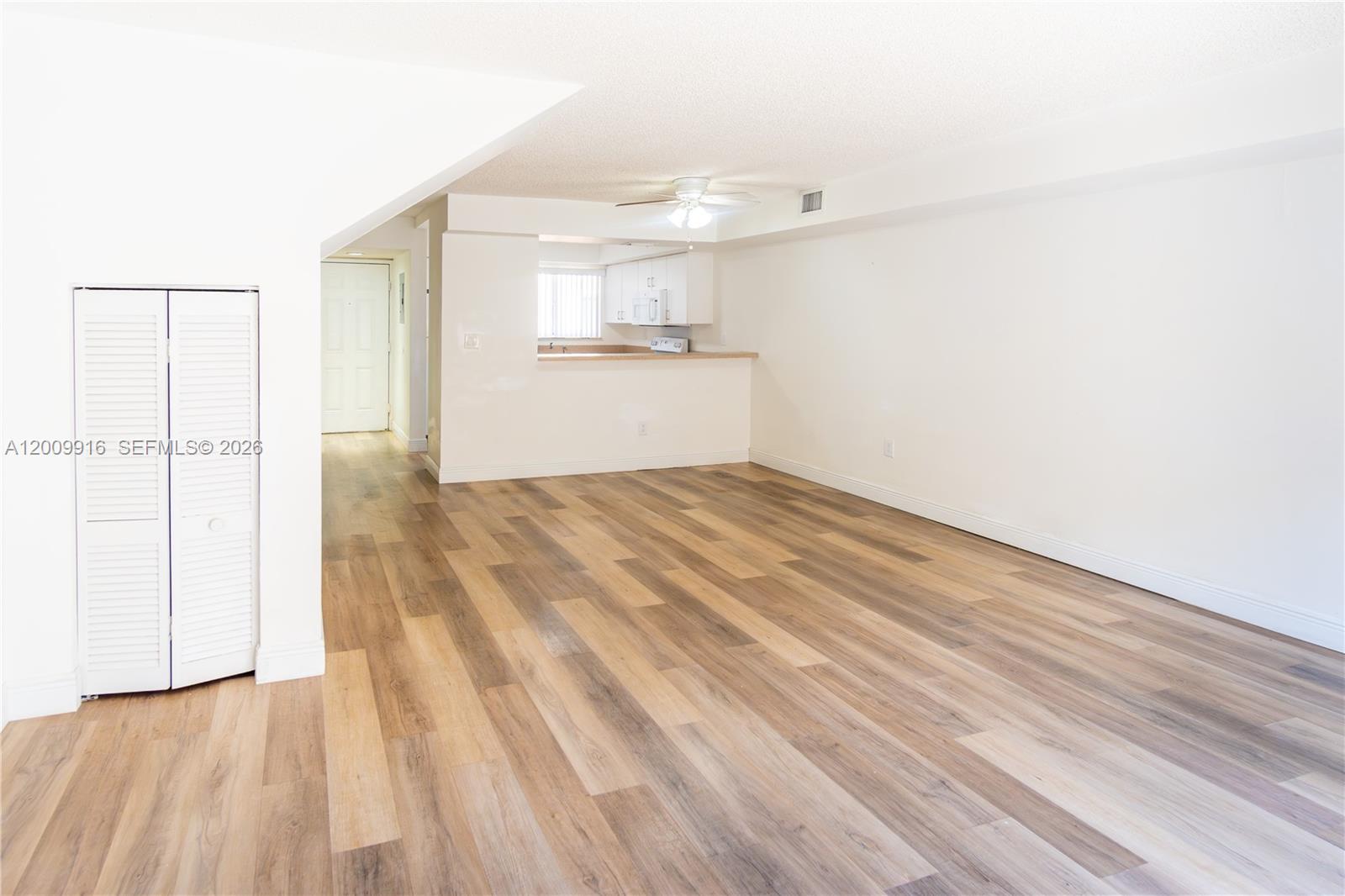 14905 Southwest 80th Street, Unit 212 Miami, FL 33193 - Photo 4 of 37 a view of a kitchen with wooden floor