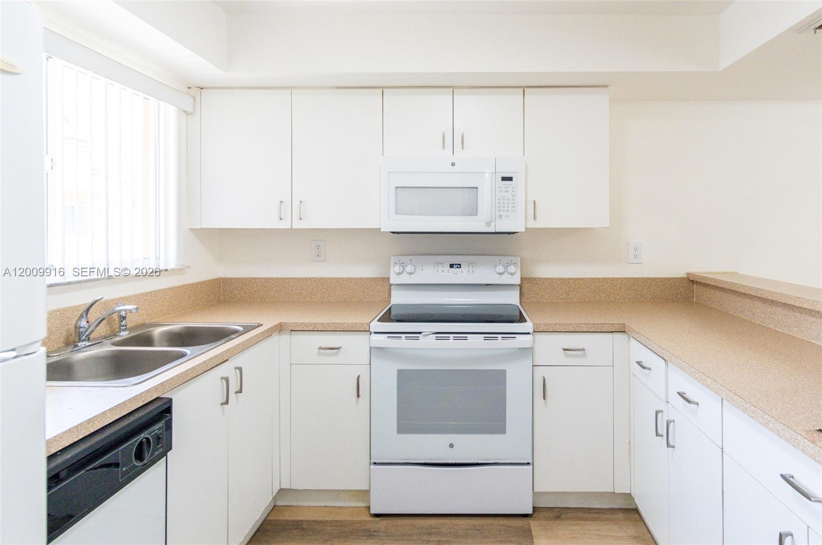 14905 Southwest 80th Street, Unit 212 Miami, FL 33193 - Photo 5 of 37 a view of a kitchen with sink and cabinets